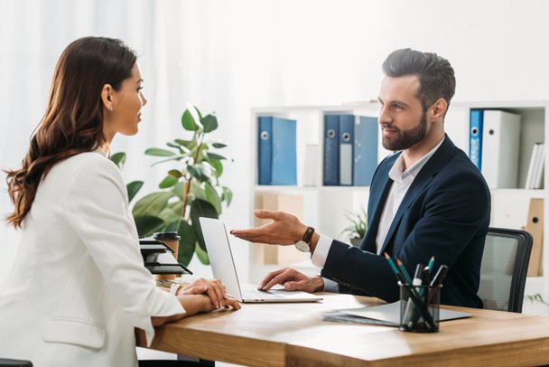 stock-photo-handsome-advisor-suit-talking-beautiful-investor-office